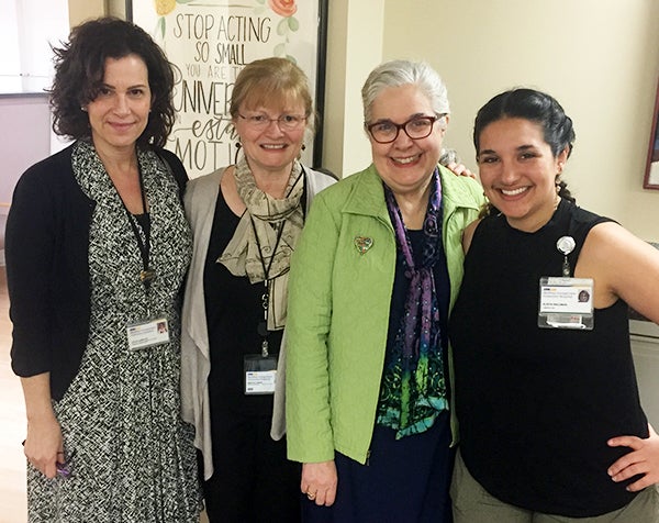 Four women stand side by side