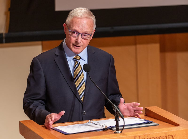 A man speaks at a podium