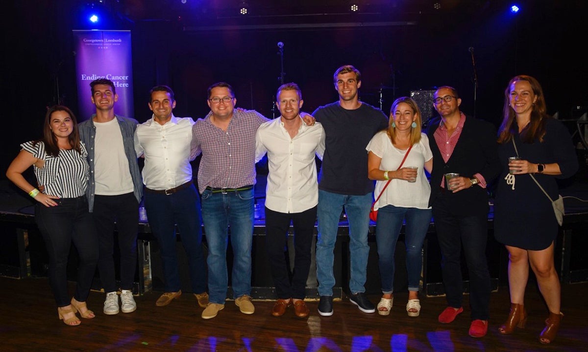 A group of young people stand together at a concert