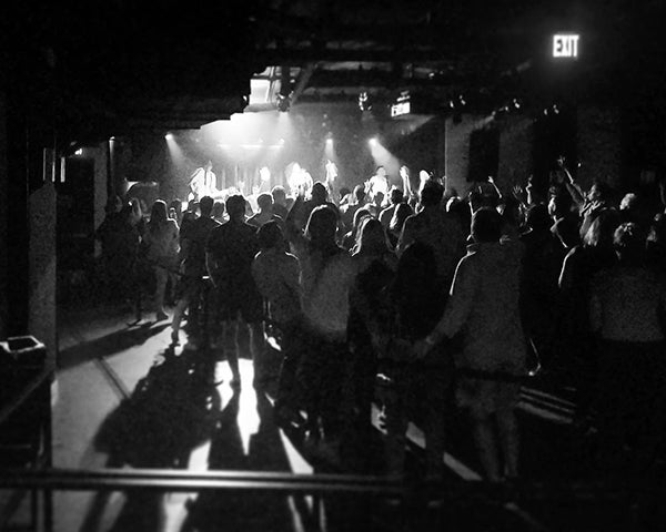 A band plays onstage before a crowd