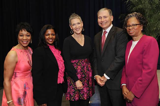 Five people stand together at the event