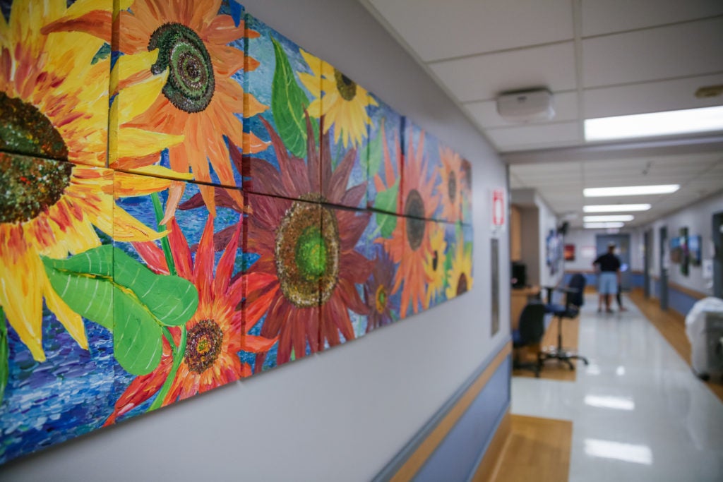 A hospital hallway decorated by a bright mural