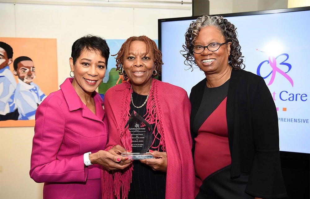 Three women stand together