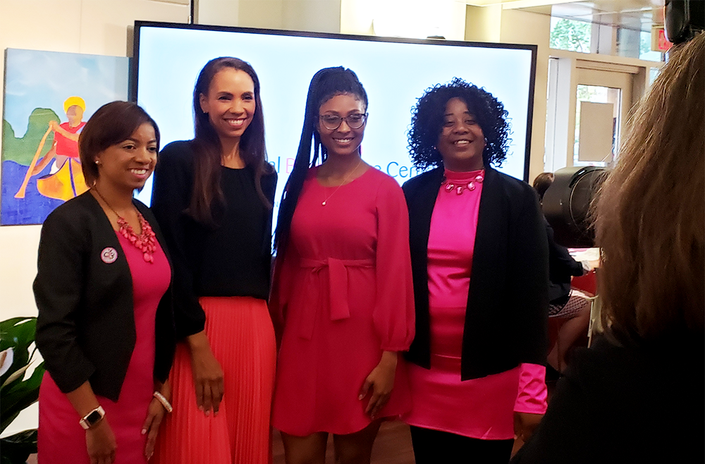 Four women stand side by side