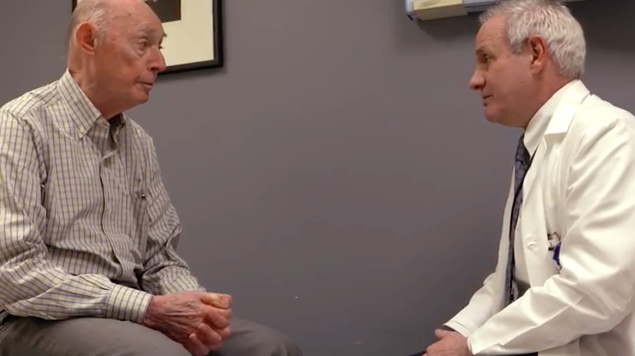 Stanley Sher sits across from Dr. Michael Atkins