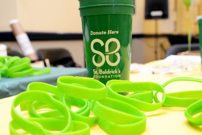 A green cup and green wristbands for St. Baldrick's