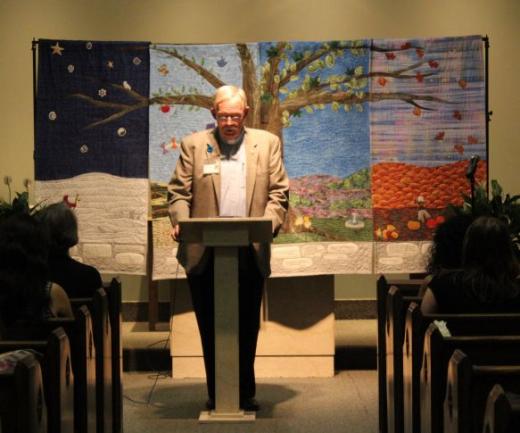 A man speaks from behind a podium