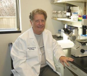 Dr. Richard Schlegel sits in his lab