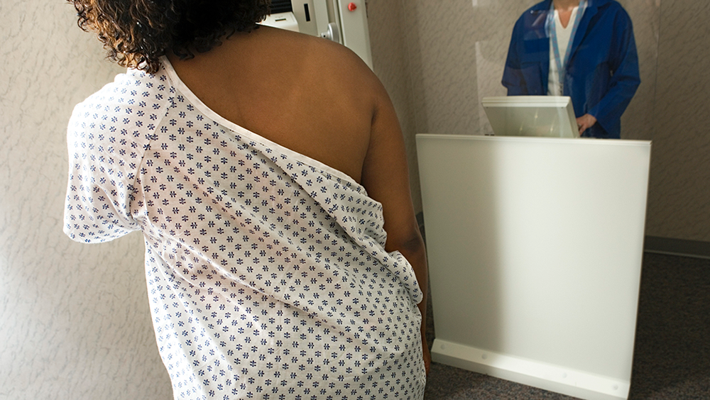 A woman receives a mammogram