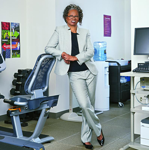 Lucile Adams-Campbell stands amid exercise equipment in a lab setting