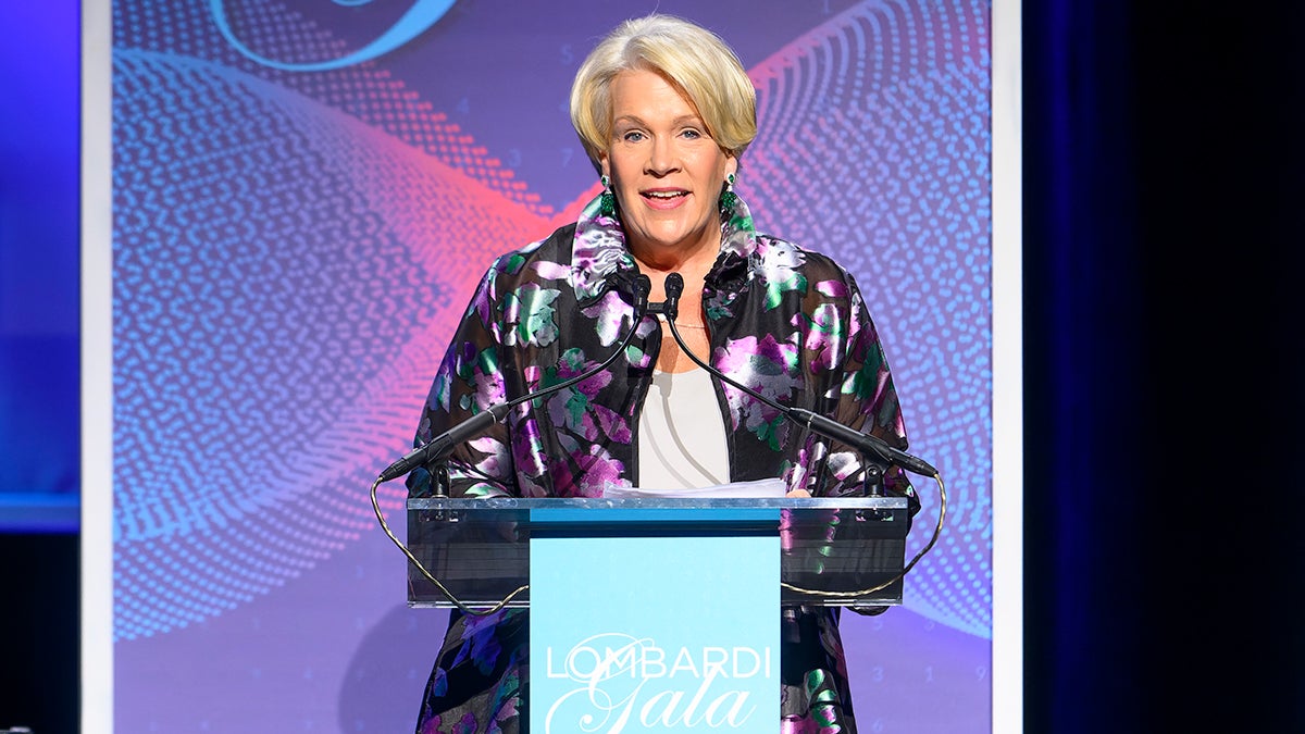 A woman stands at a podium