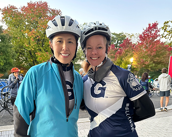 Susan Cheng and Kristi Graves stand side by side in biking gear