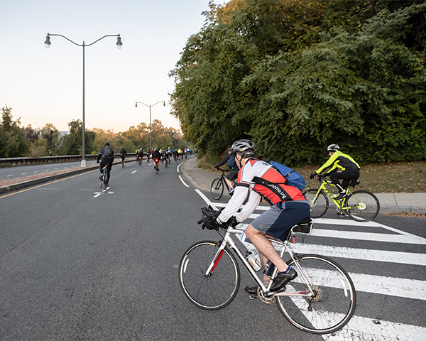 Riders turn onto Canal Road near Georgetown University