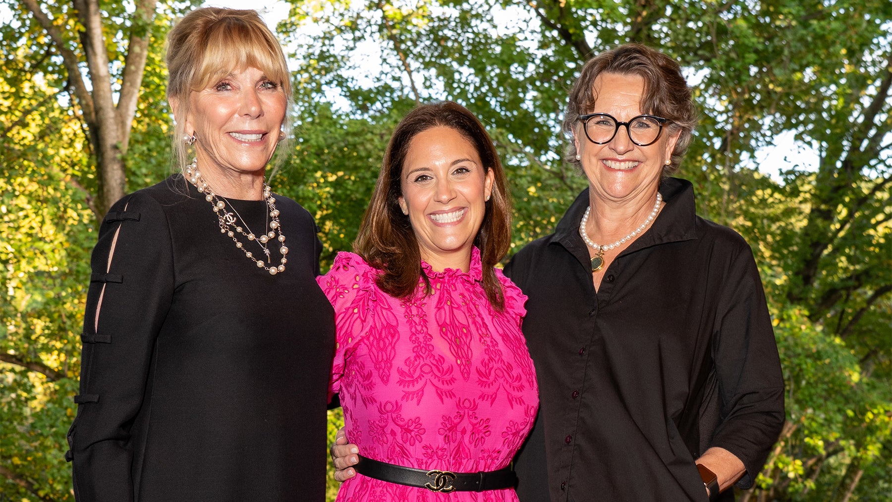 Three women stand together