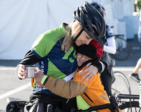 A ride participant hugs her son