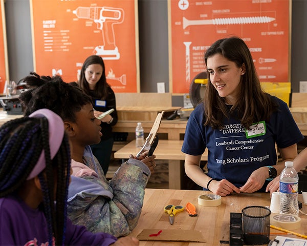 Mary Rose interacts with children doing a craft activity