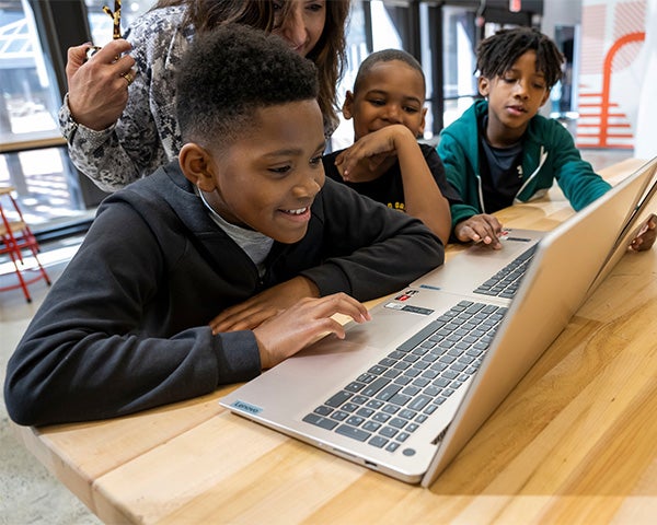 Children work at a computer