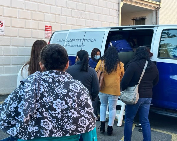 Women make their way to the Ralph Lauren Center van