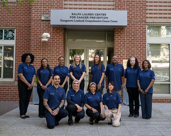 A group of Ralph Lauren staff members stand together outside the center