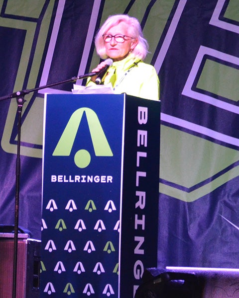 Lisa Boyle speaks from a podium on a stage