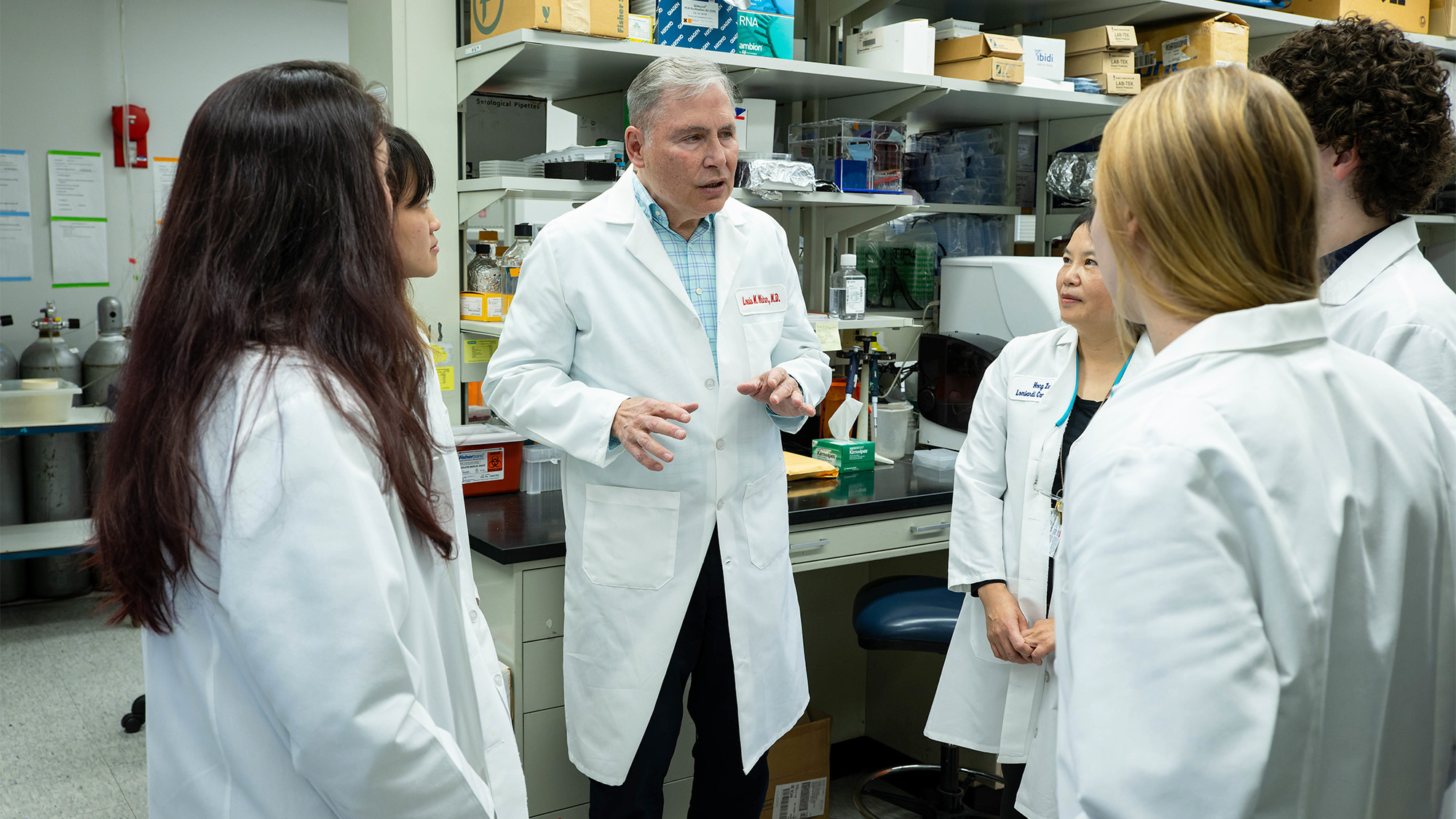 Dr. Weiner speaks with members of his lab