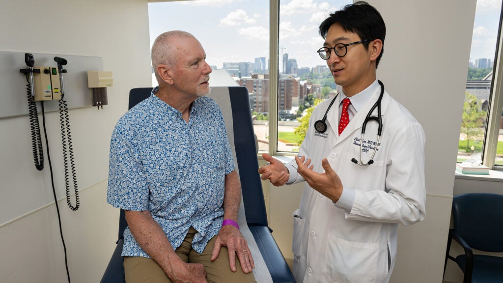 Dr. Chul Kim speaks with a patient