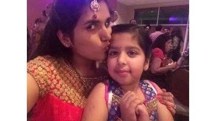 Ritu kisses her younger sister fondly