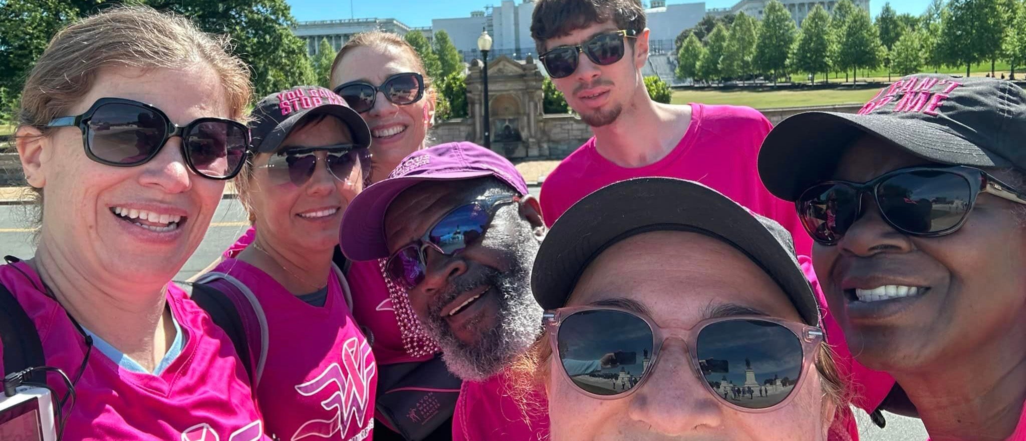 A group of people wearing pink celebrate on behalf of the Walking Warriors