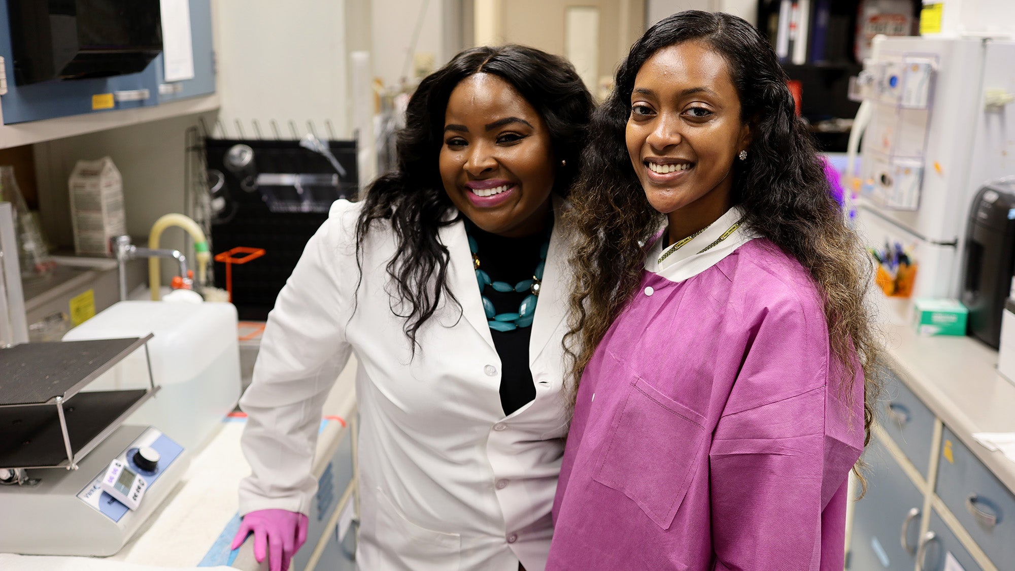 Martha Gay and student stand together in a lab