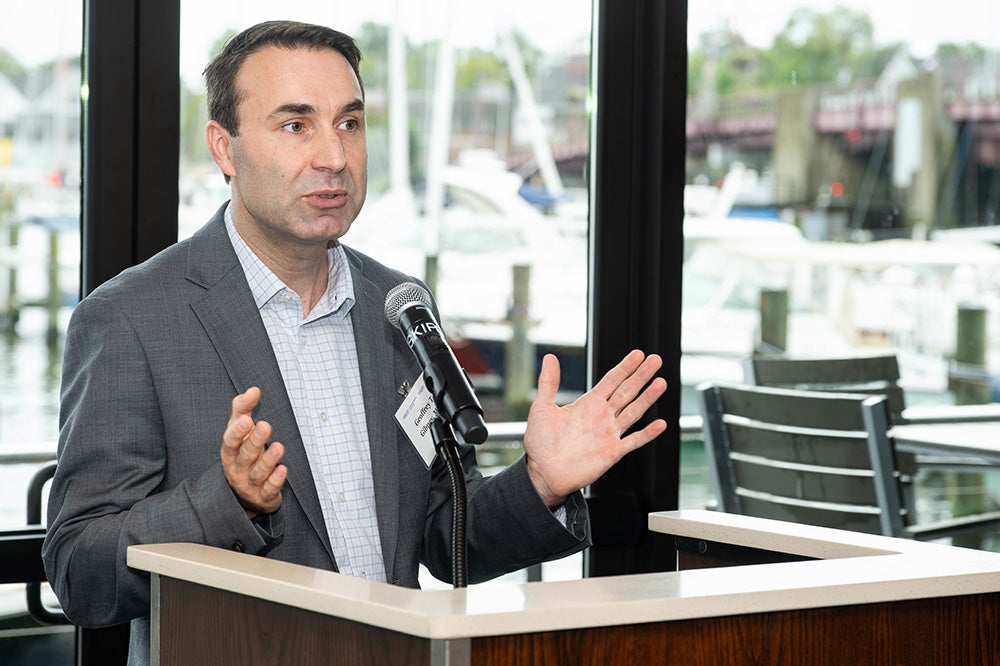 Dr. Gibney speaks from a podium