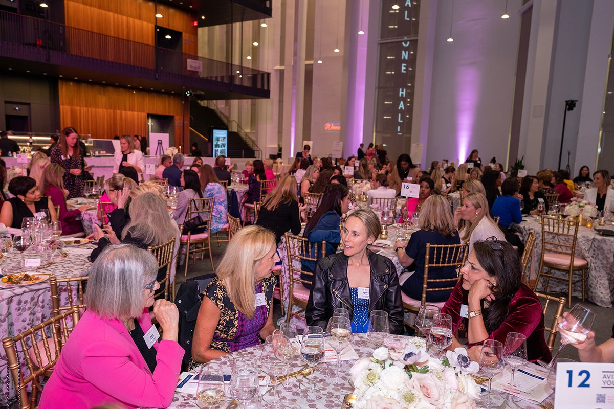 An overview of the room filled with tables and attendees at Lombardi Women