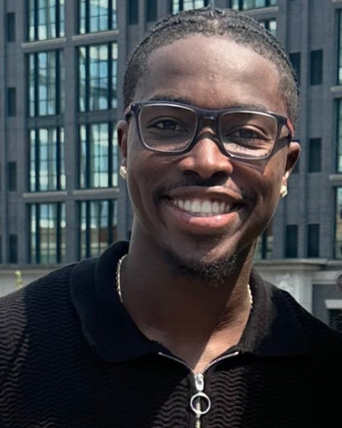 Chris Leby is a Black man pictured outdoors in the city