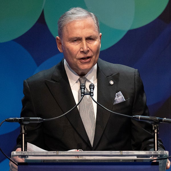 Lou Weiner speaks behind a podium