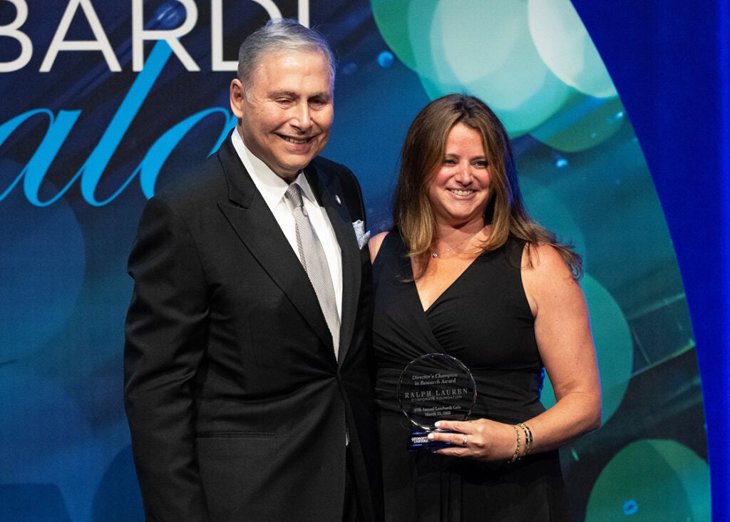 Lou Weiner and Alyssa Youngerman  stand onstage at the gala