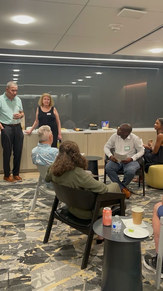 A man giving a speech while other listen