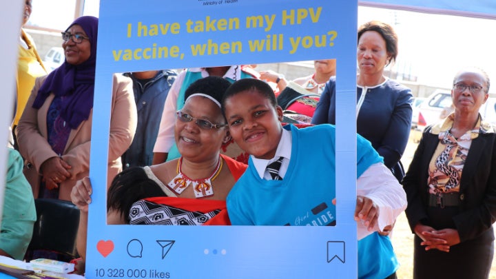 Two people pose for a picture for social media