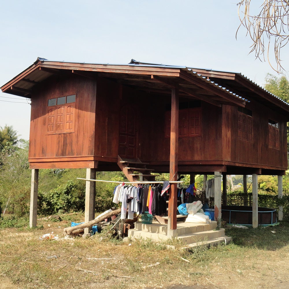 A Thai house in a lowland village on stilts with clothing hanging beneath it