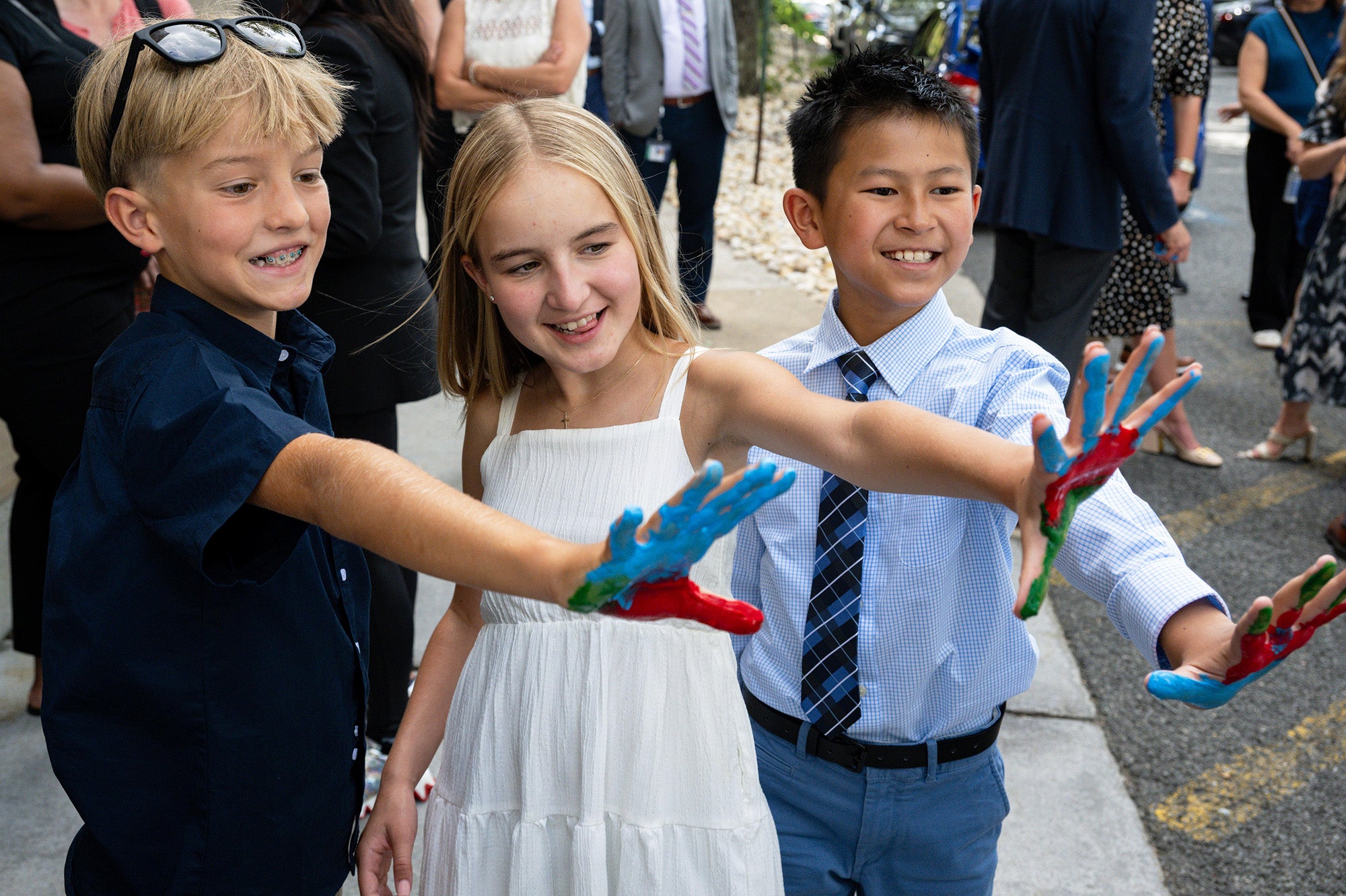Three children who are Hyundai Hope on Wheels Ambassadors display painted hands