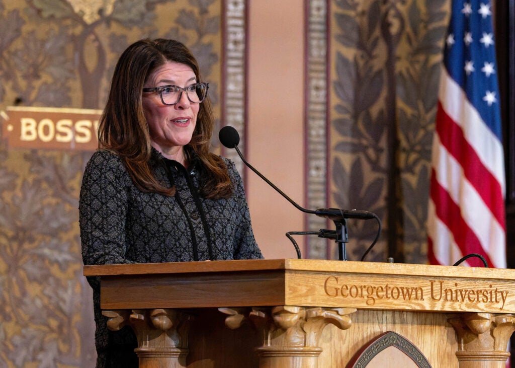 Alex Kovach speaks from the podium in Gaston Hall