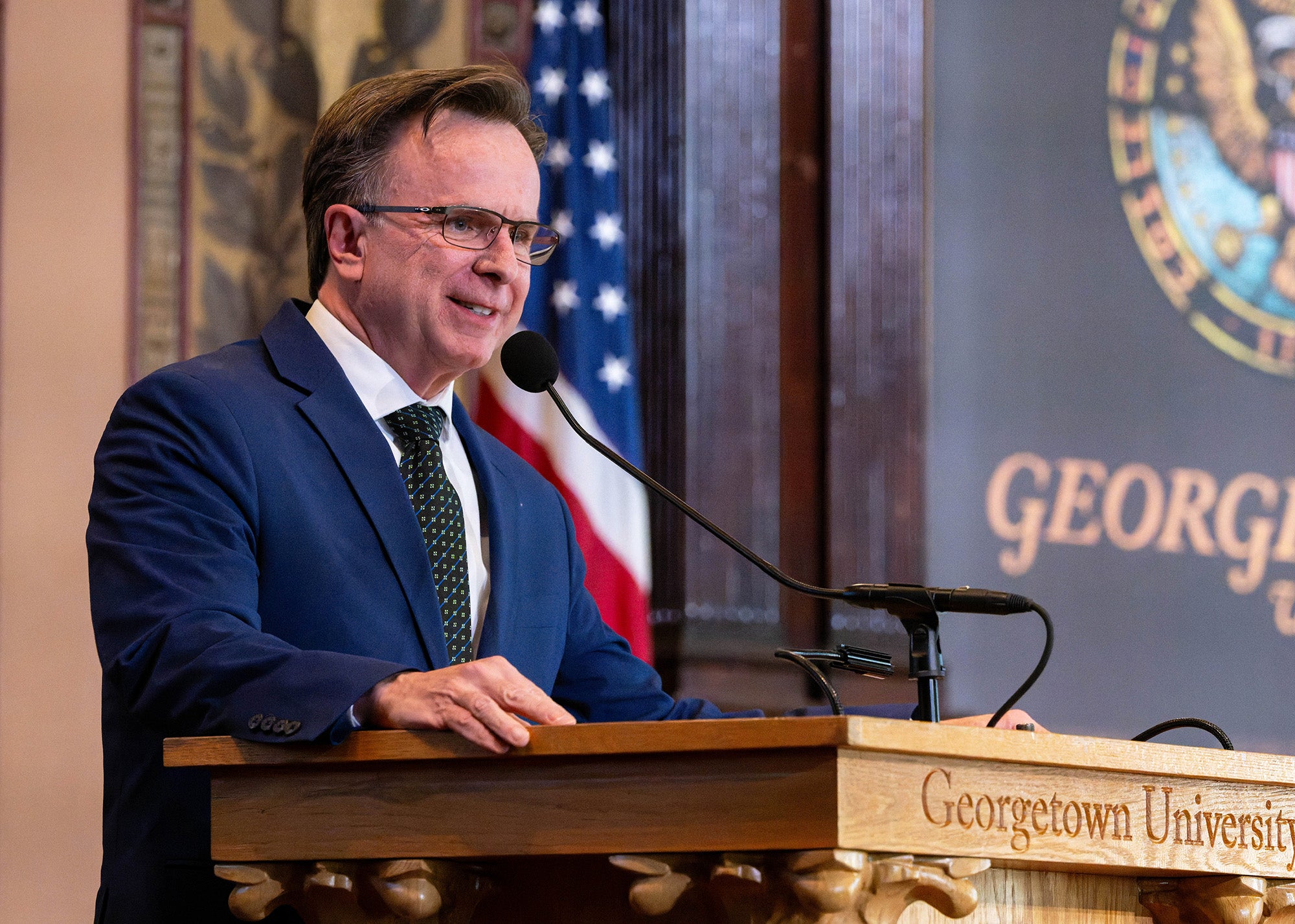 Norman Beauchamp speaks from the podium in Gaston Hall