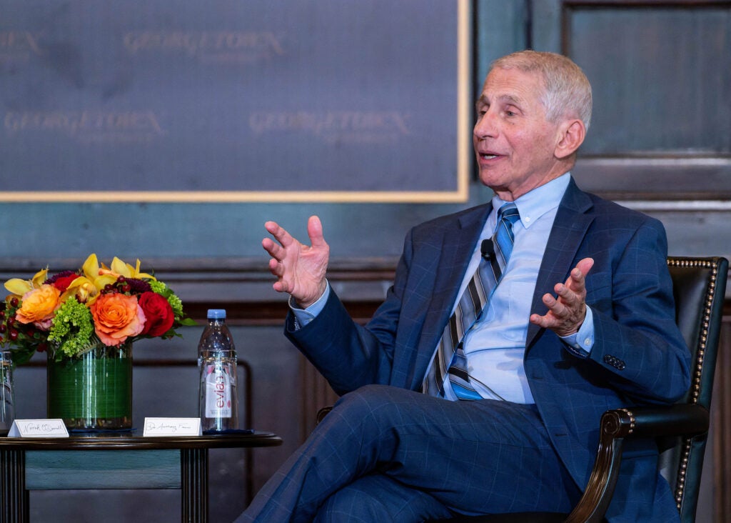 Seated onstage in Gaston Hall, Anthony Fauci speaks