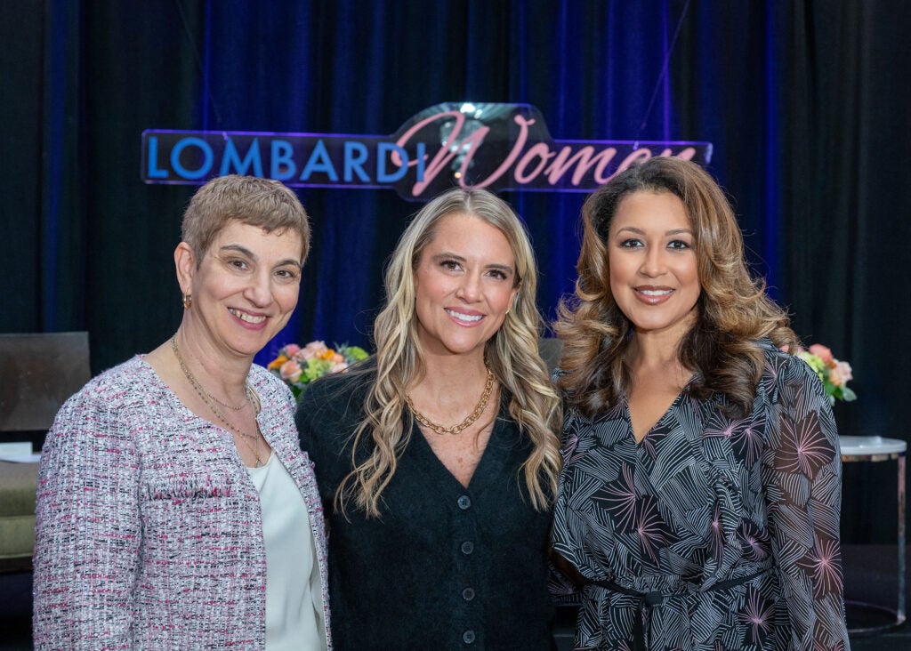 Three women stand together
