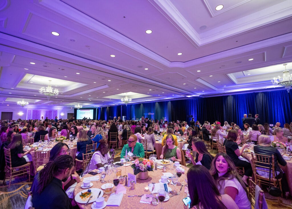 A room filled with Lombardi Women attendees seated at tables