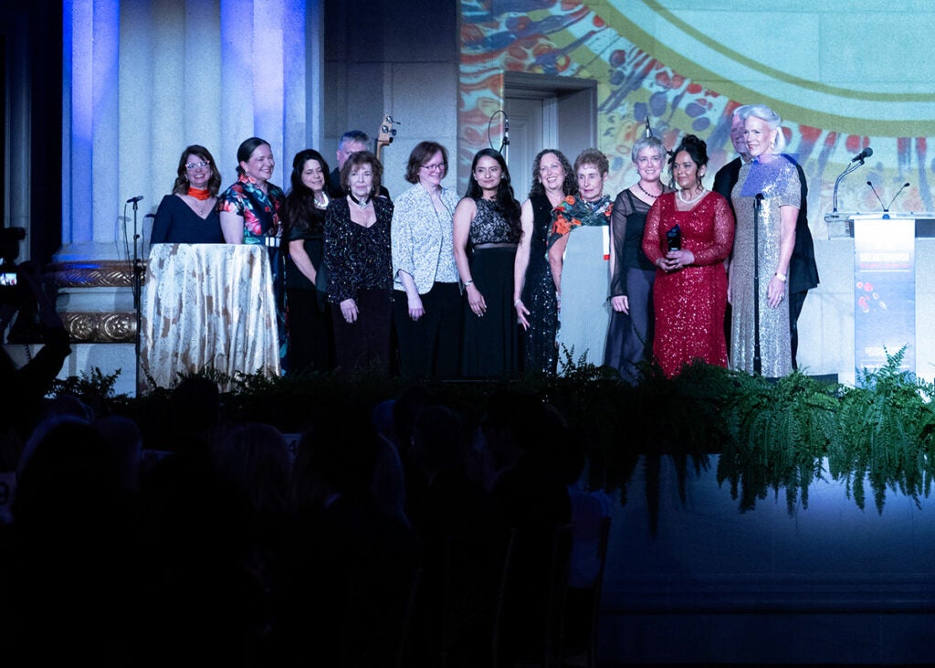 The GBCA members stand onstage in a group with Dr. Shajahan-Haq and Laurie Lapeyre and Walter Hodges 