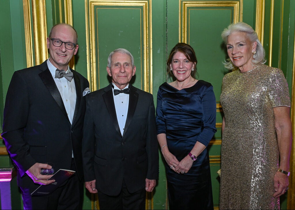 Four individuals stand together