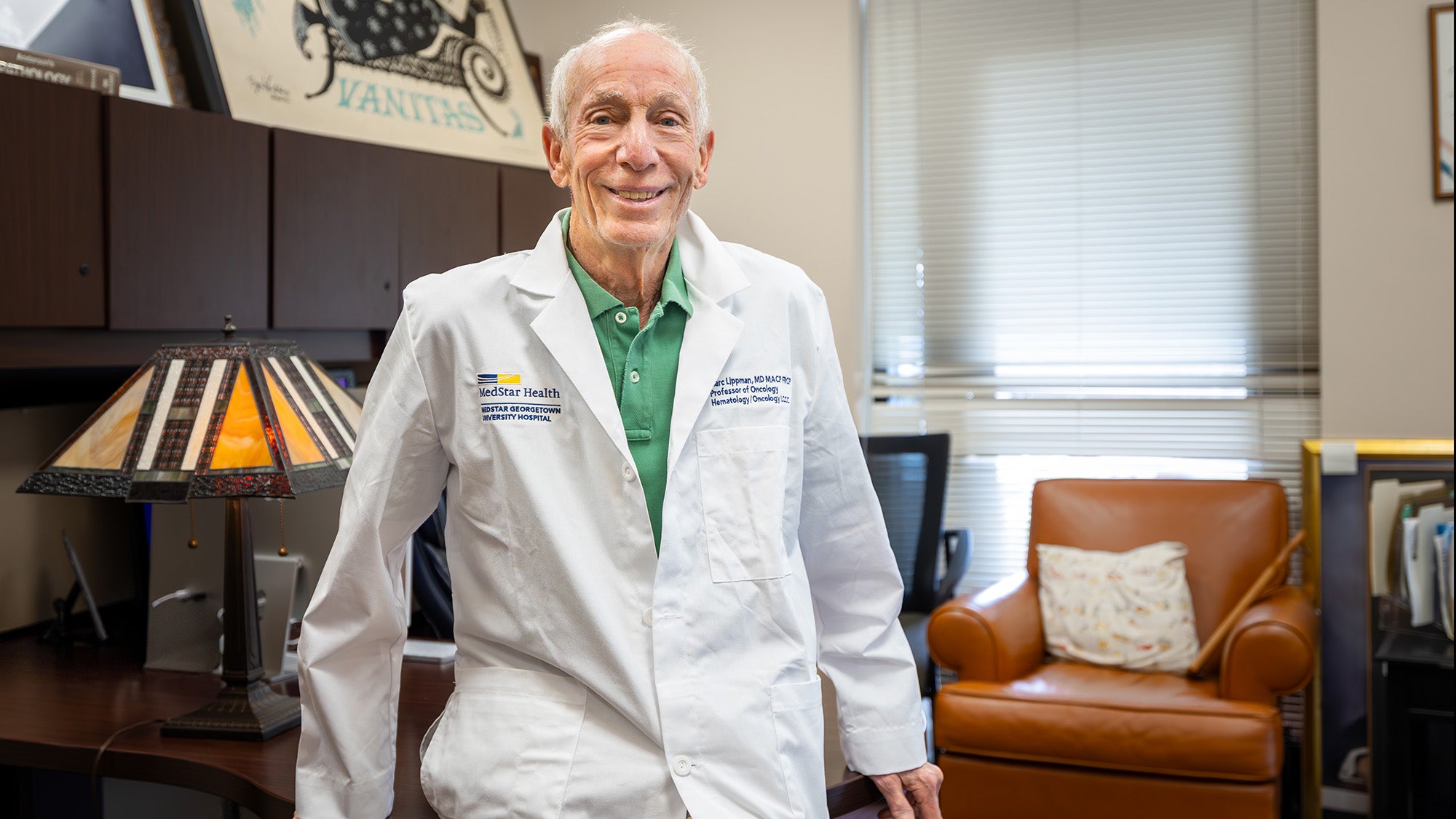 Dr. Marc Lippman, wearing his white medical coat, in his office