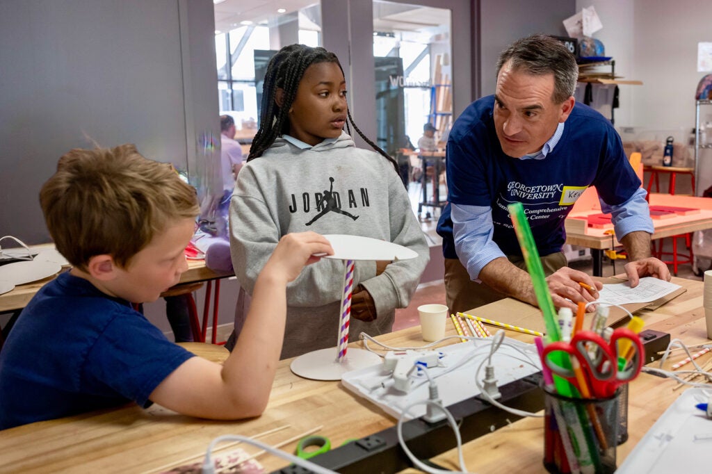 Dr. Tercyak assists two students with an activity