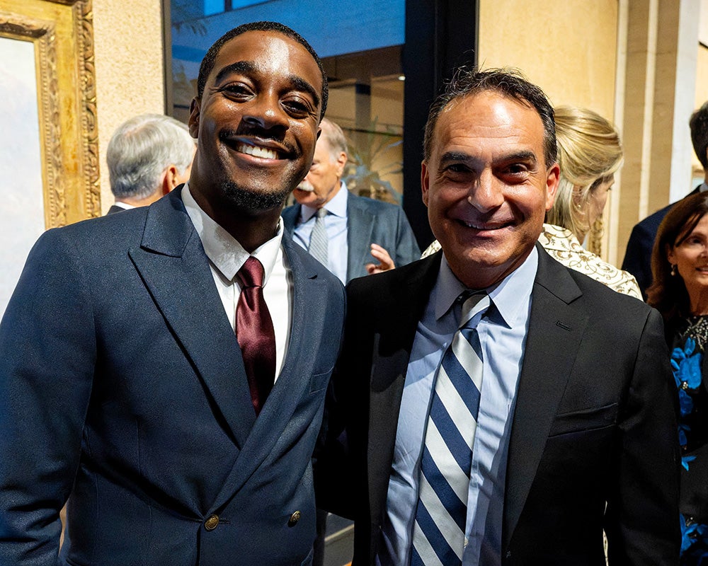 Kishon Chambers and Ken Tercyak stand together in a crowded room