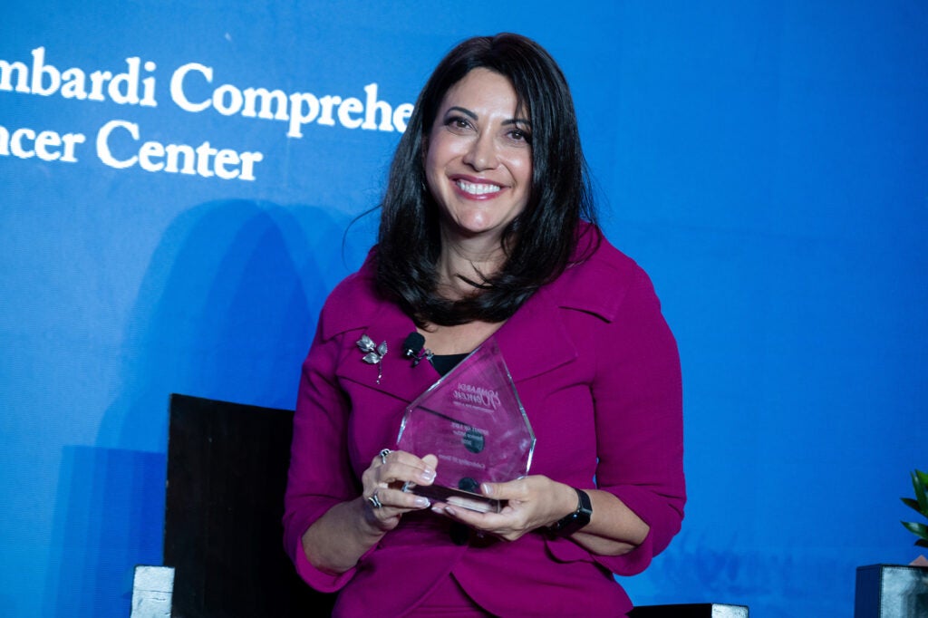 Jessica Miller holds a glass award