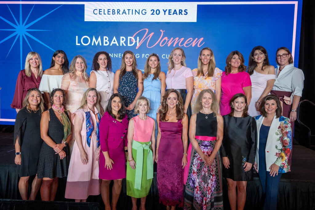 A large group of women stand together